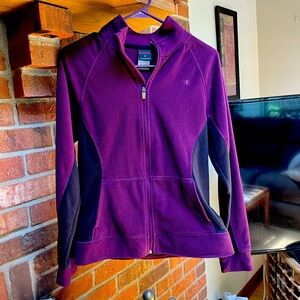Champion purple and black zip-up jacket with pockets.